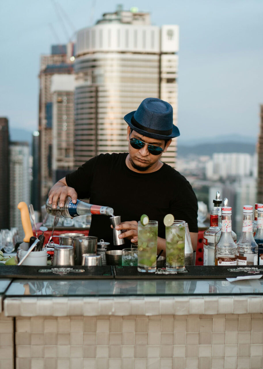 bartender-kuala-lumpur-914x1280-1 Bartender preparing cocktails at a rooftop bar in Kuala Lumpur