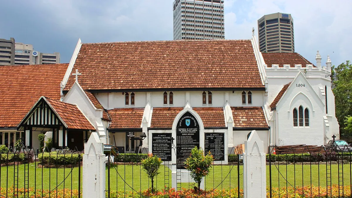 St Marys Cathedral Kuala Lumpur St. Mary’s Cathedral in Kuala Lumpur with a red-tiled roof and city skyscrapers behind it
